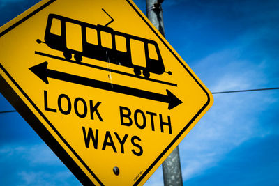 Low angle view of road sign against sky