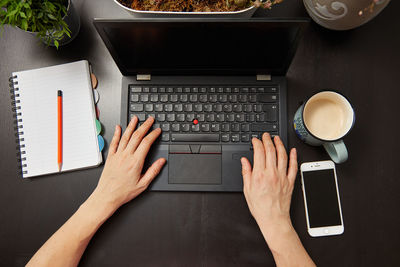 Directly above view of man using laptop on table