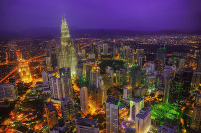 High angle view of illuminated buildings in city at night