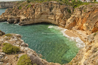 High angle view of rocks on sea shore