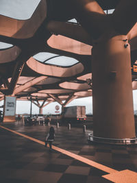 Woman standing on railroad station platform