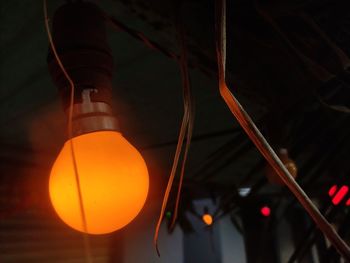 Low angle view of illuminated lighting equipment at night