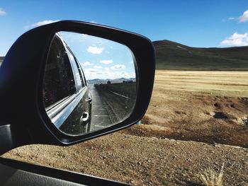 Reflection of car on side-view mirror