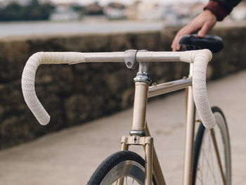 Close-up of person holding bicycle