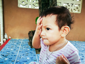 Cute boy sitting outdoors