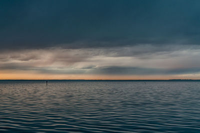 Scenic view of sea against sky during sunset after storm