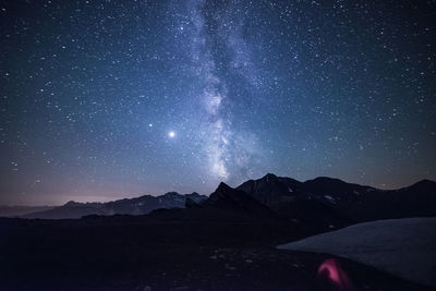 Scenic view of mountains against sky at night