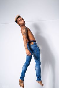 Young man looking away against white background