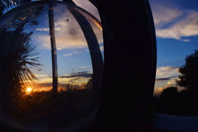 Close-up of silhouette window against sunset sky