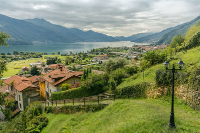 Houses in town against cloudy sky