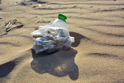 High angle view of garbage on sand at beach