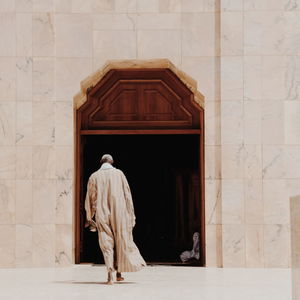 Rear view of man standing against wall