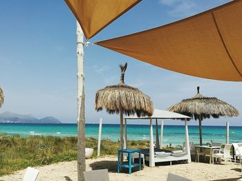 Scenic view of beach against blue sky