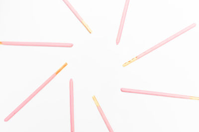 Close-up of colored pencils against white background