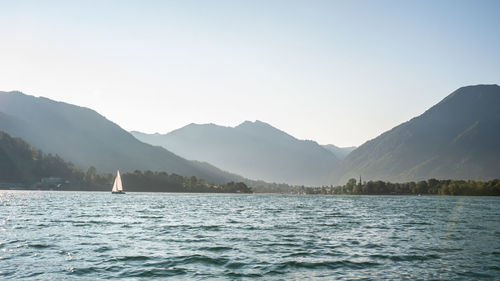 Scenic view of lake and mountains against clear sky