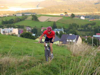 Woman riding bicycle on field