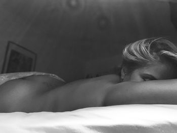 Portrait of woman sleeping on bed