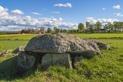 Hay bales on field against sky