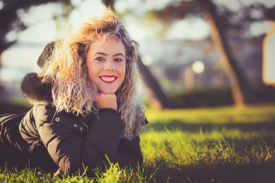 Portrait of a smiling young woman on field