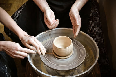 Master class on modeling of clay on a potter's wheel in the pottery workshop