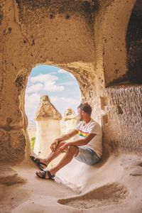 Side view of man sitting in old historic building