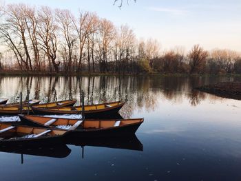 Boats moored in lake against sky