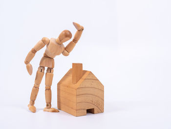 Close-up of figurine on table against white background