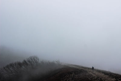 Scenic view of landscape against sky during foggy weather