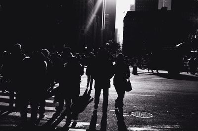 Woman standing in city at night