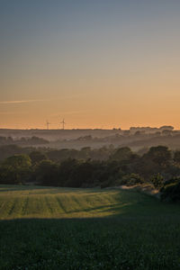 Scenic view of field against sky during sunset