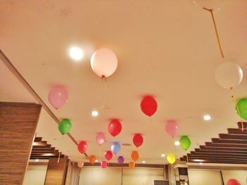 Low angle view of balloons against ceiling