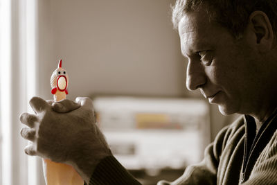 Close-up of man holding toy