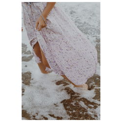 Low section of woman standing on shore at beach