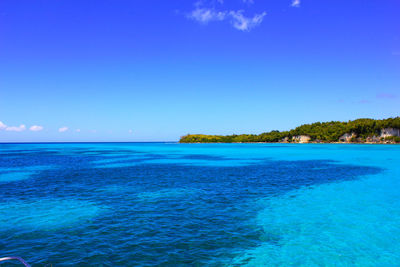 Scenic view of sea against clear blue sky