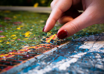 Close-up of hand holding jigsaw puzzle piece