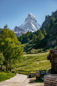 Scenic view of field and mountains against sky