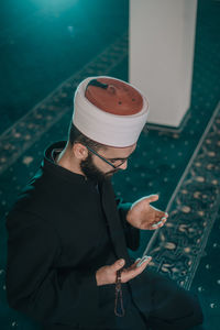 Midsection of man holding mobile phone