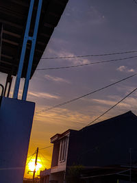 Low angle view of silhouette buildings against sky during sunset