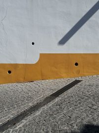 Close-up of yellow shadow on wall