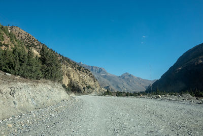 Scenic view of mountains against clear blue sky