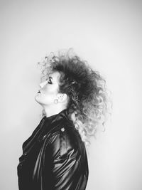 Portrait of young woman against white background