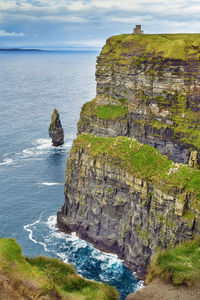 Rock formations by sea against sky