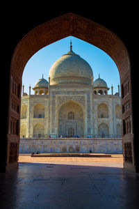 Taj mahal seen through archway