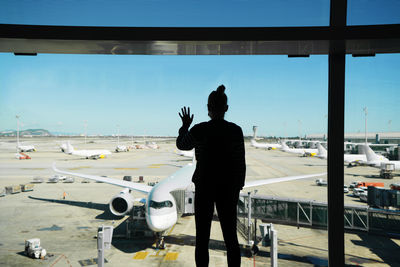 Woman standing by the window at the airport