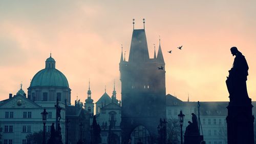 Statues and architectural buildings during sunset