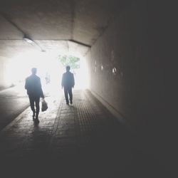 Full length of woman walking in tunnel