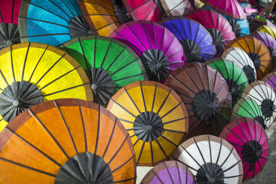 Colorful handmade paper umbrellas at traditional street night market in luang prabang, laos.