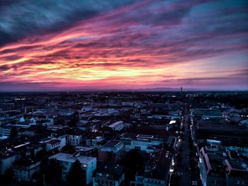 High angle view of illuminated cityscape against sky during sunset