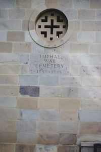 Close-up of text on brick wall