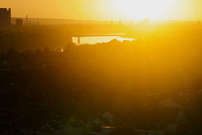 Scenic view of buildings against sky during sunset